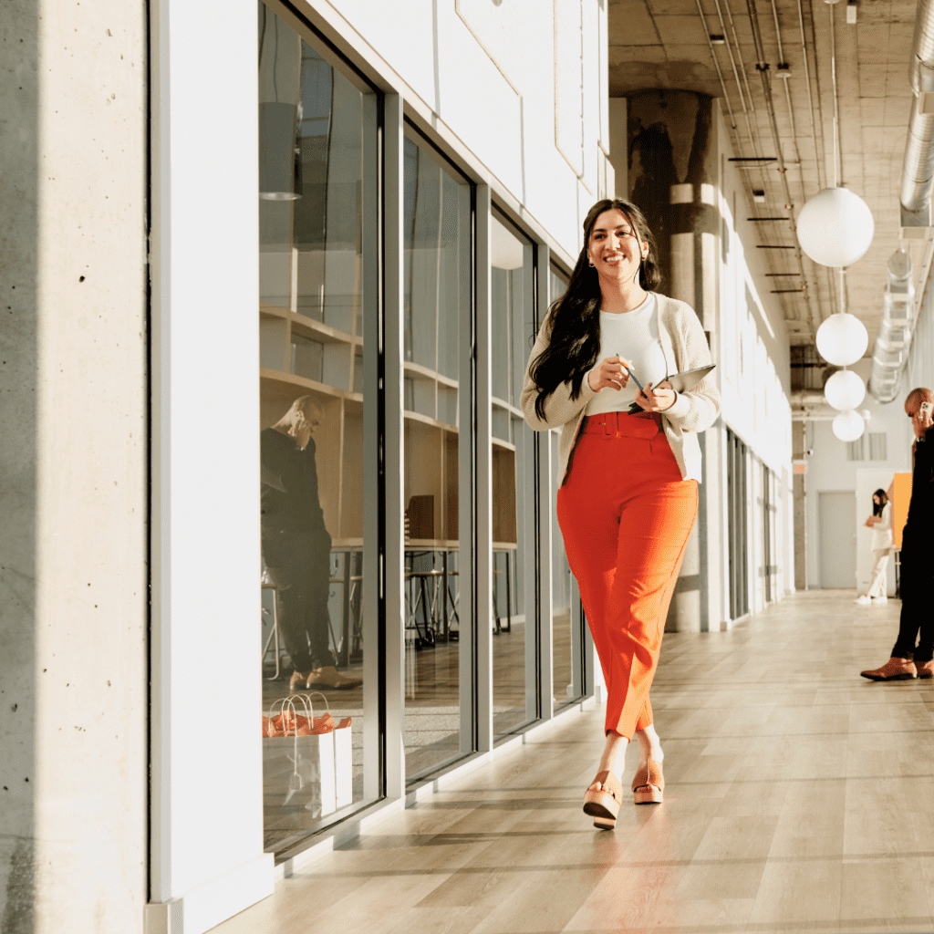 Young employee walking down an office hallway